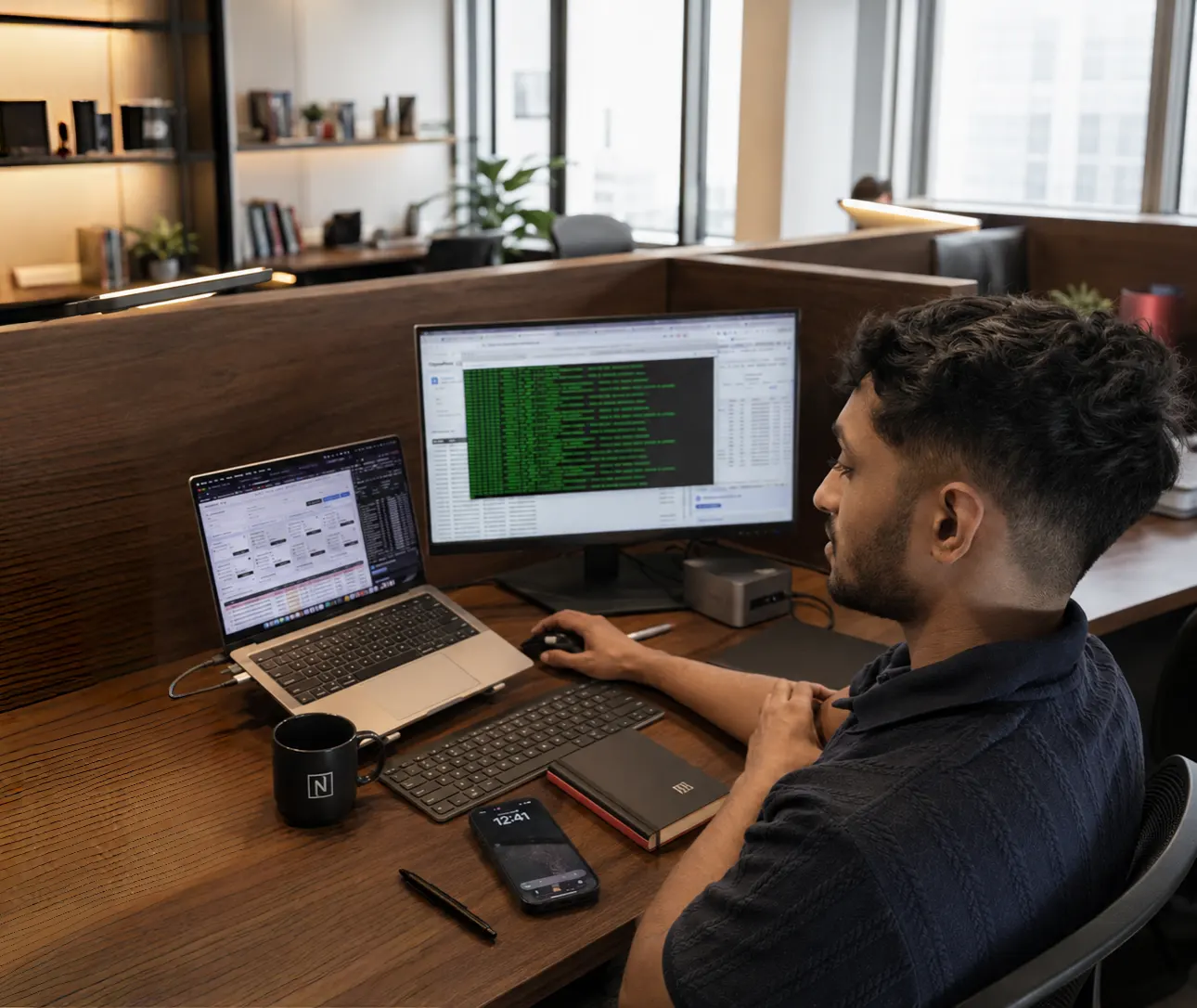 Team working with documents on dual monitors